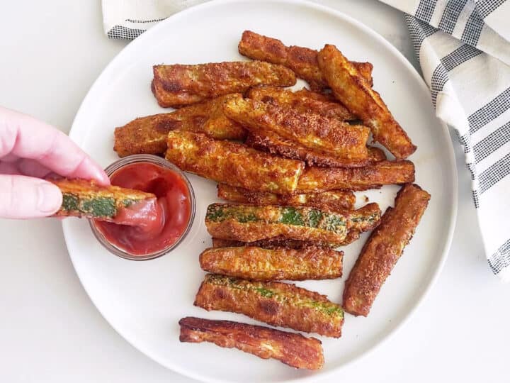 A fry is dipped in ketchup.