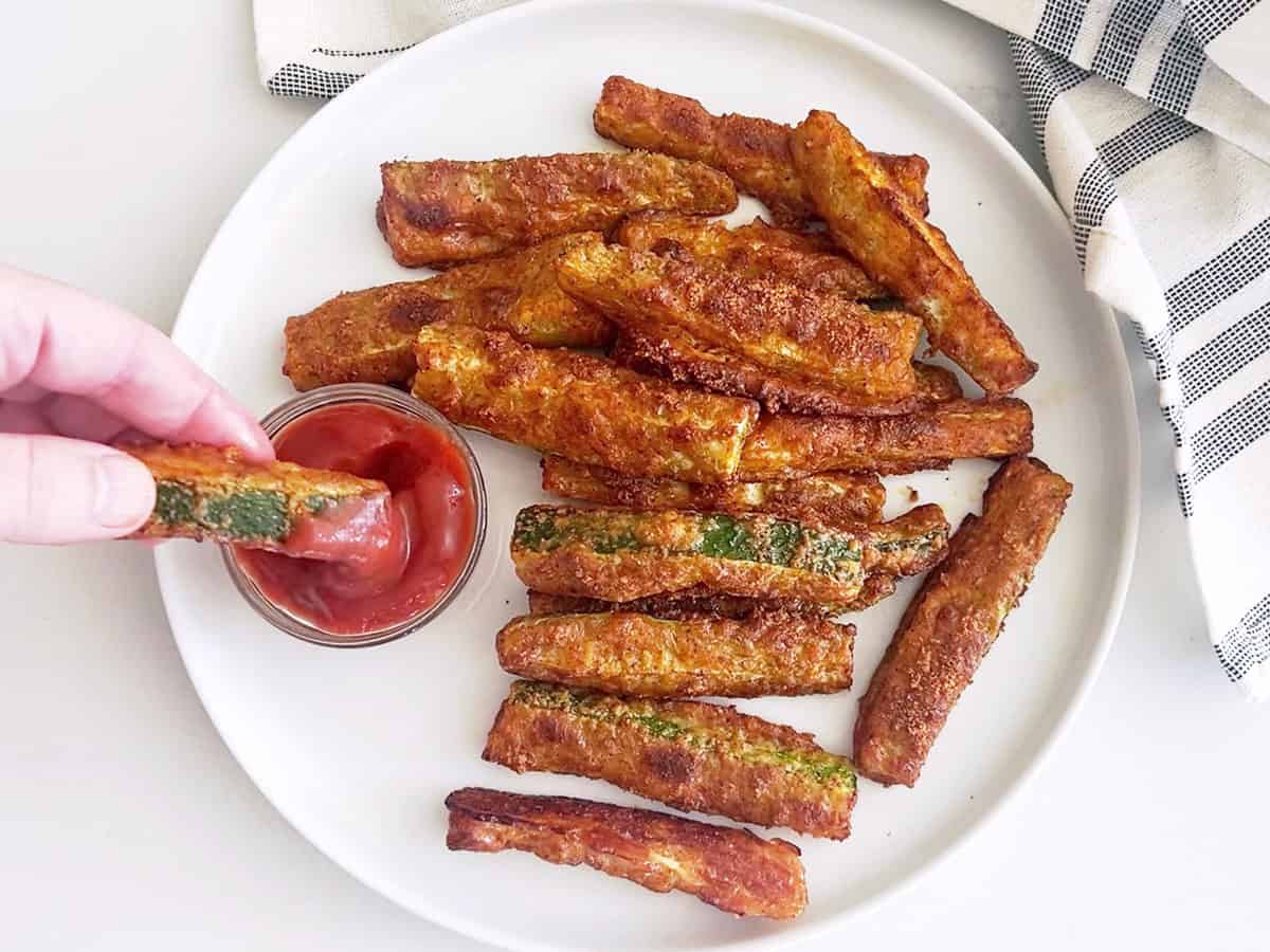 A fry is dipped in ketchup.