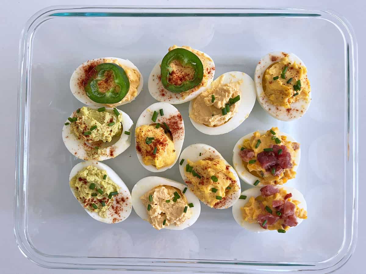 Deviled eggs leftovers in a glass storage container.