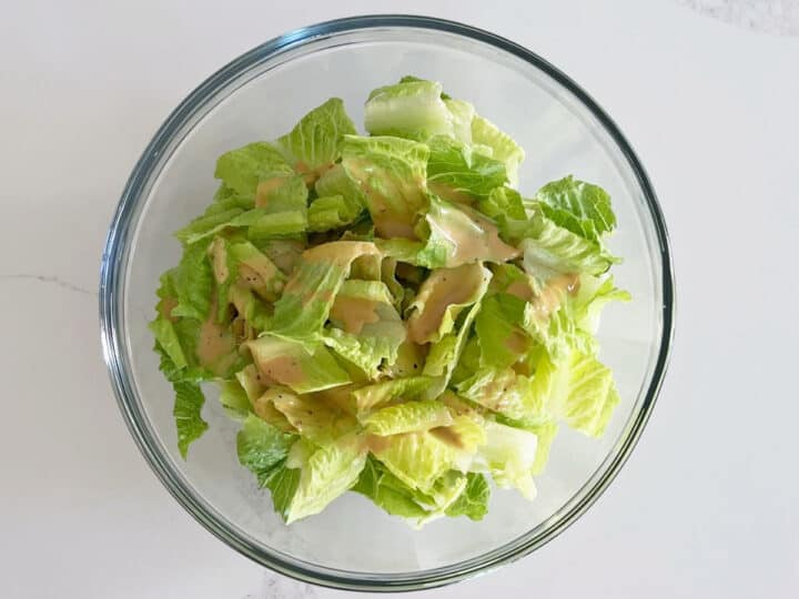 The dressing was added to the salad.