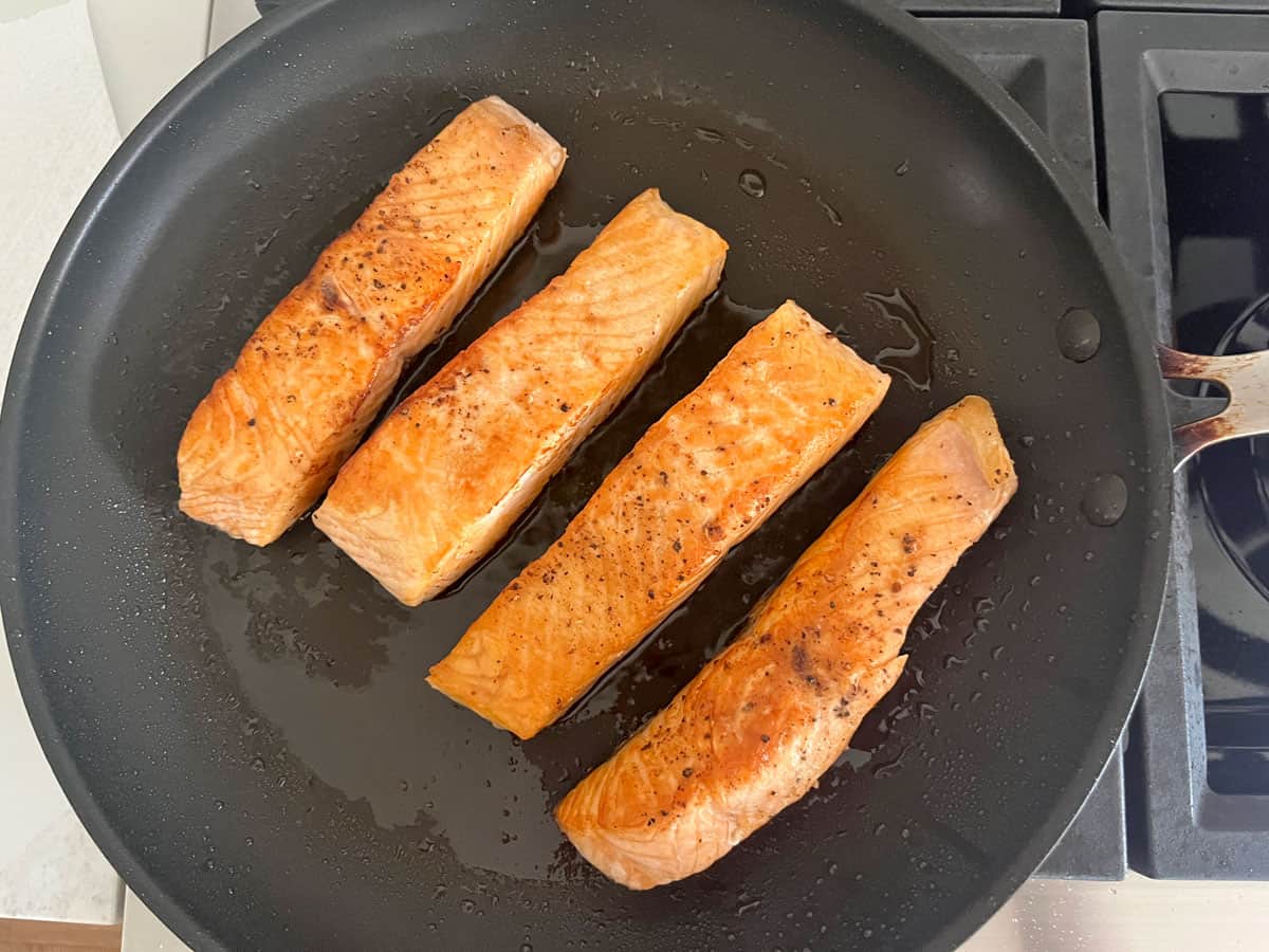 Pan-frying the salmon.
