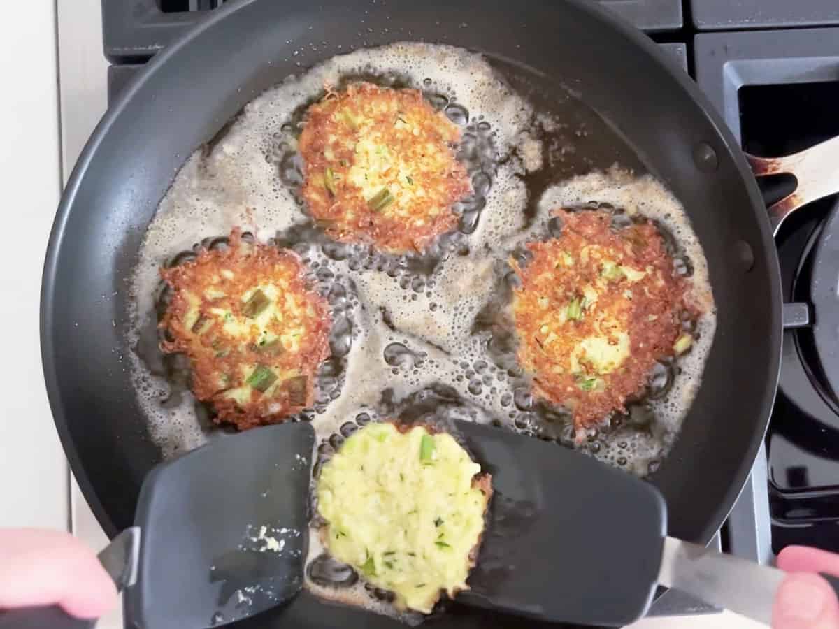 Frying the fritters in a skillet.