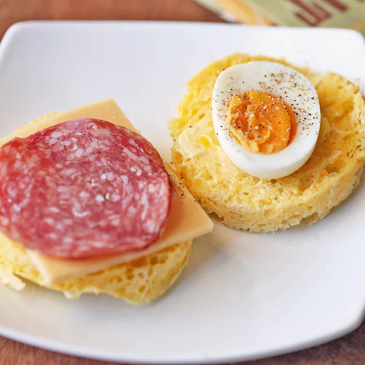 Untoasted 90 second bread is topped with cheese, salami, and egg.