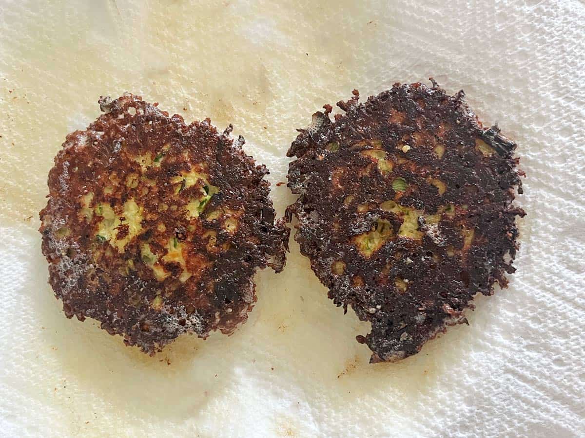 Two burnt zucchini fritters.