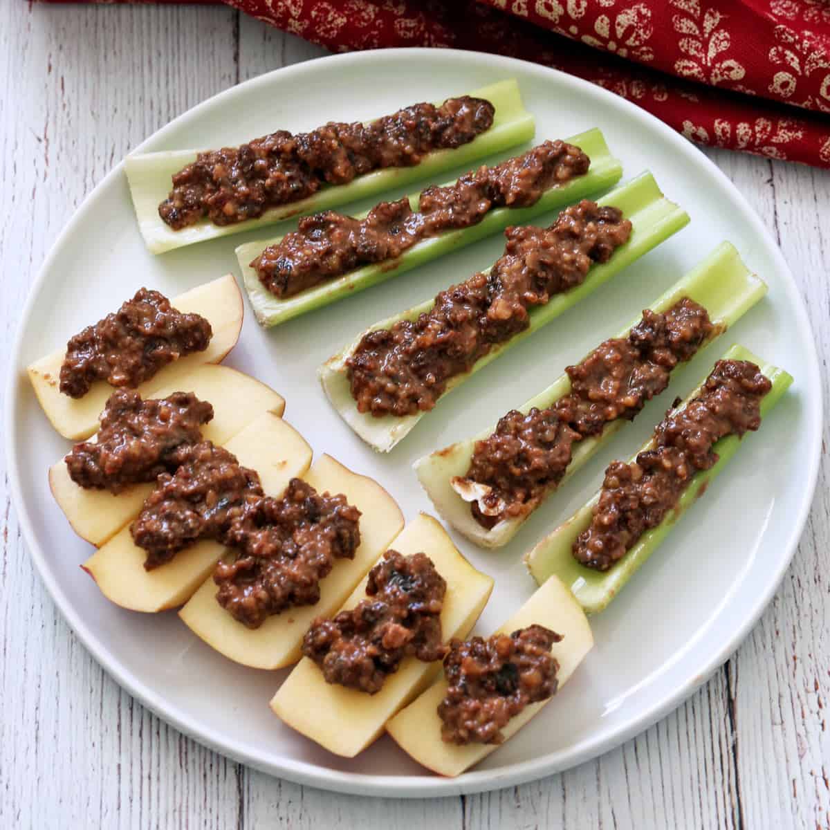 Apple slices and celery stalks are topped with leftover charoset.