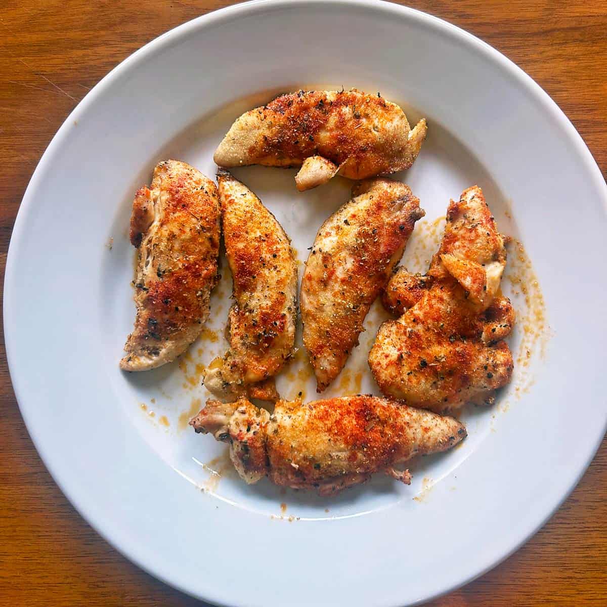 Baked chicken tenders on a plate.