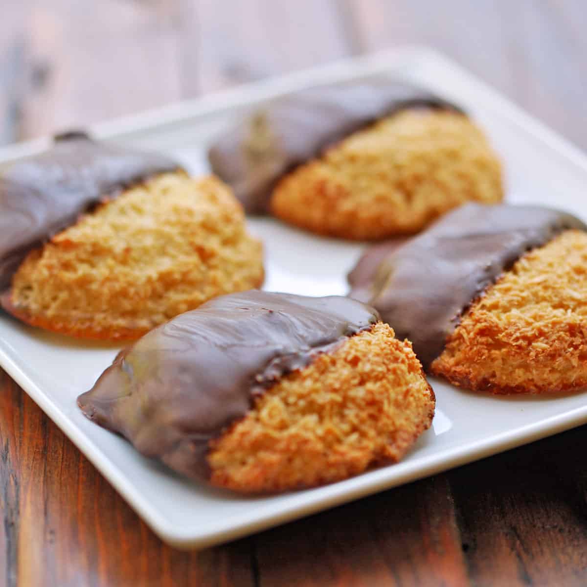 Chocolate dipped coconut macaroons on a plate.