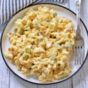 Egg salad is served on a plate with a fork.