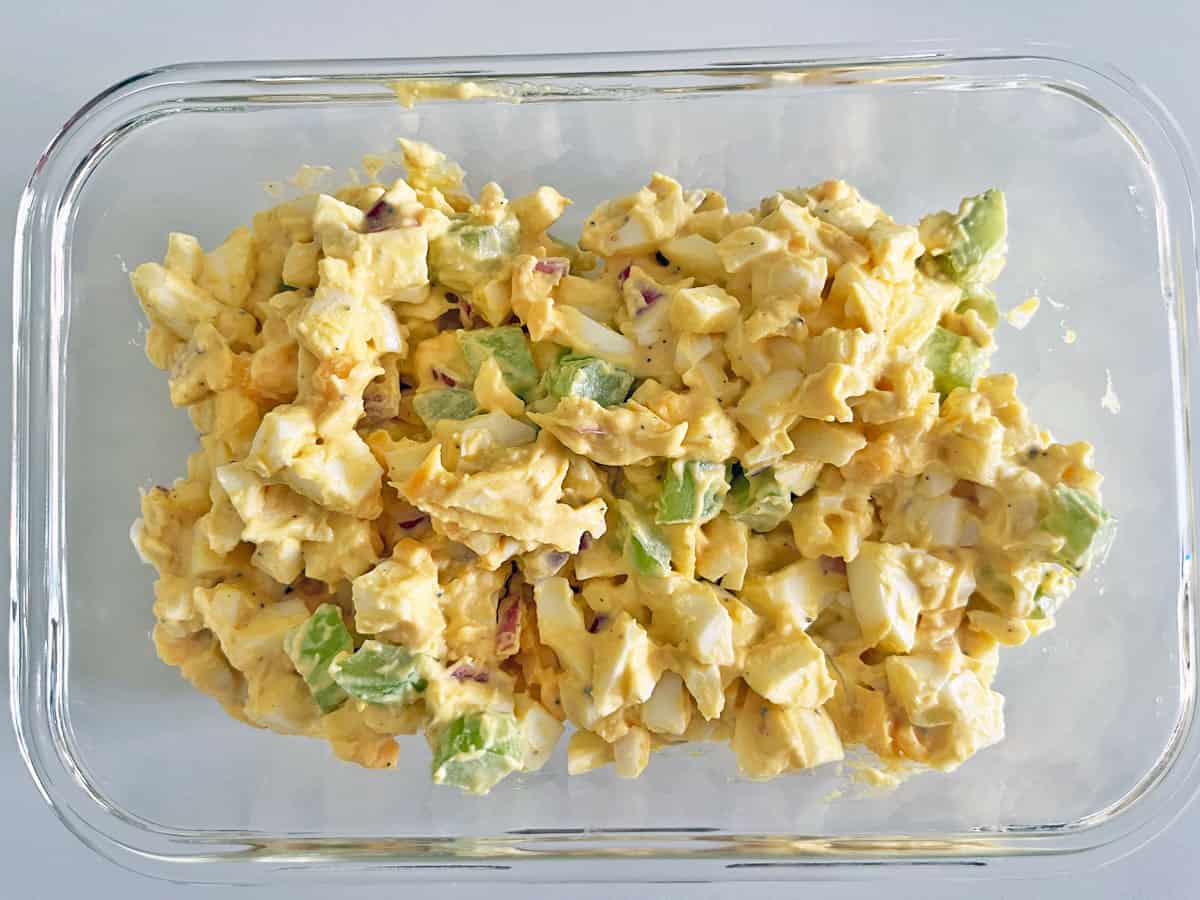 Egg salad leftovers are kept in a glass food storage container.
