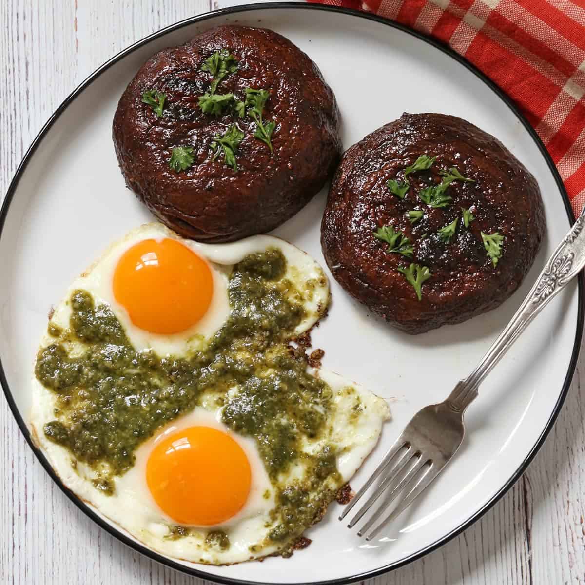 Pesto eggs are served with grilled portobellos.