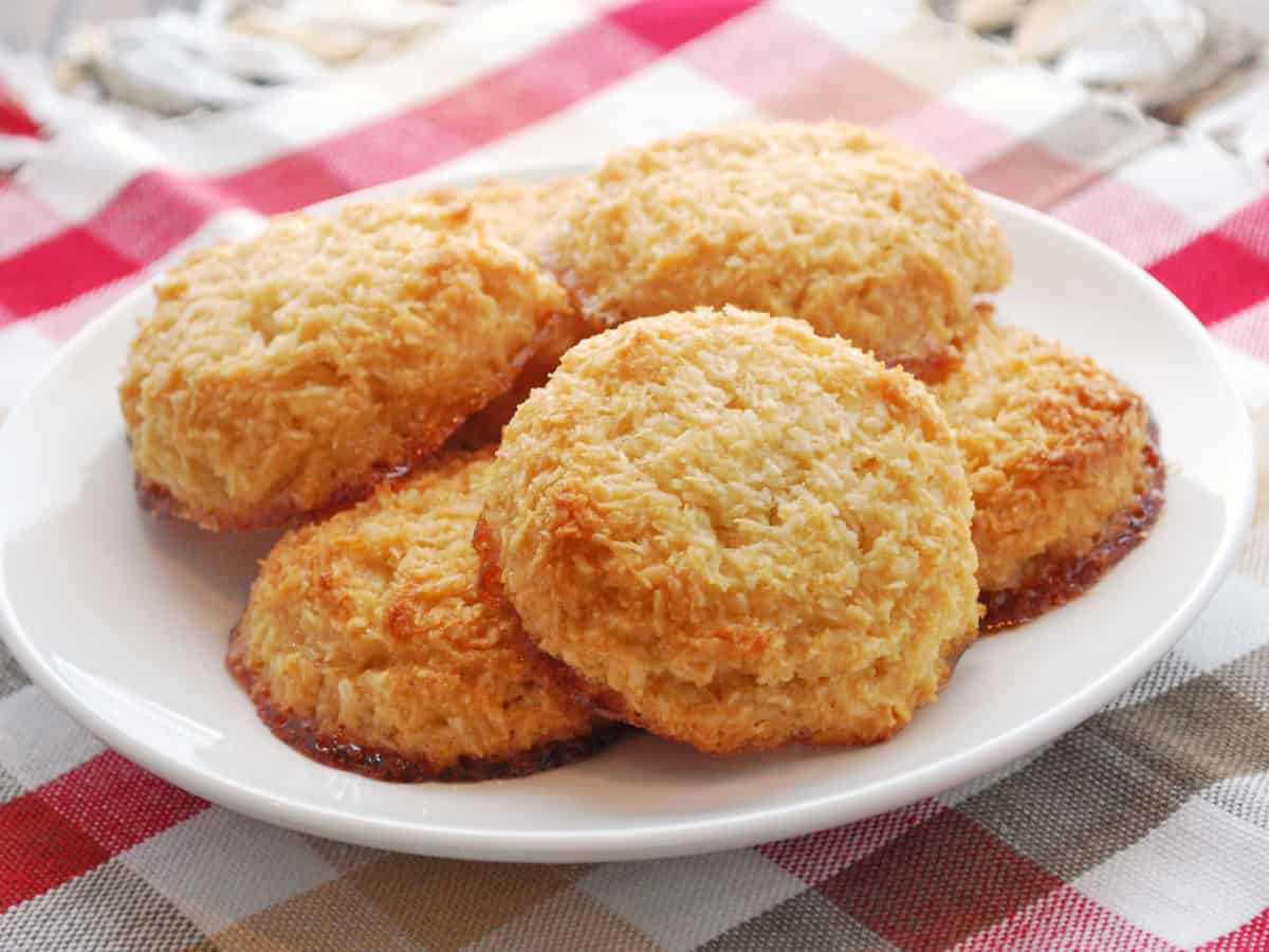 Flattened coconut macaroons on a plate.