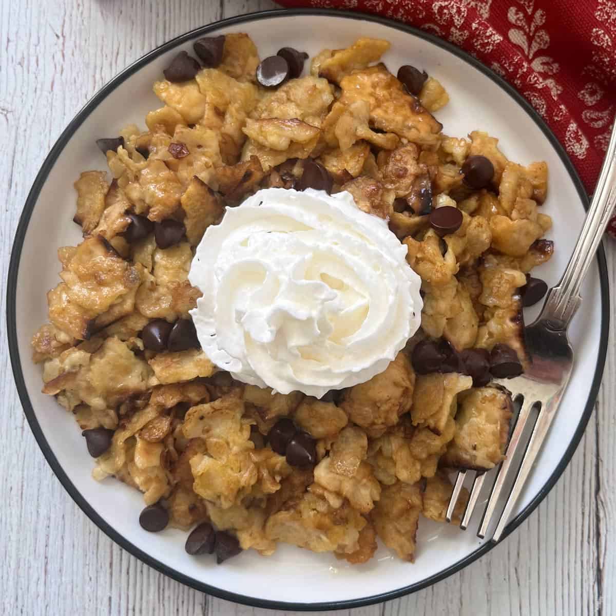 Matzo brei is topped with whipped cream.