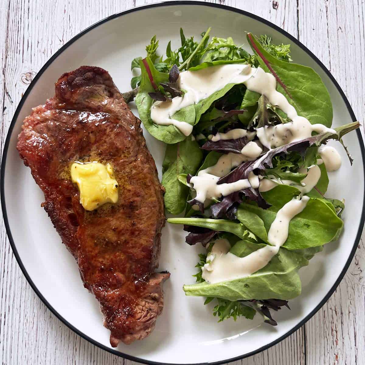 New York steak is served with a salad.