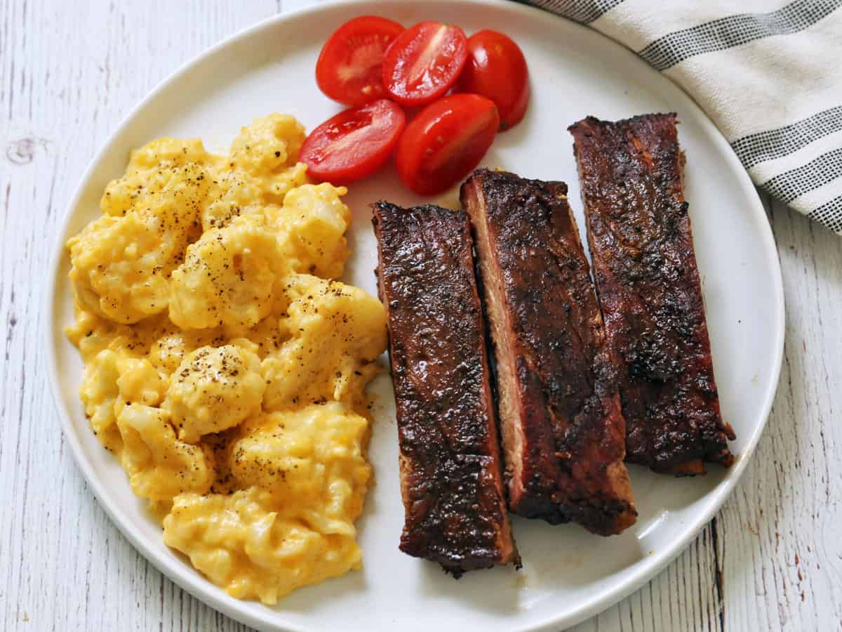 The ribs are served with cauliflower mac and cheese.