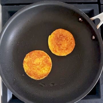 Toasting the bread in a skillet.