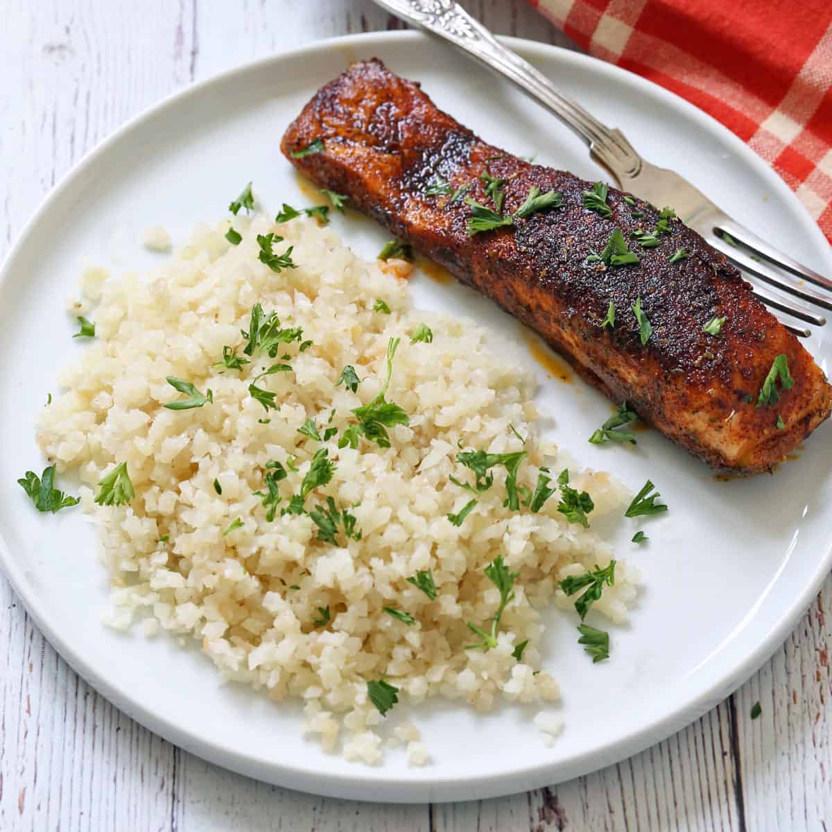 Blackened salmon is served with cauliflower rice.