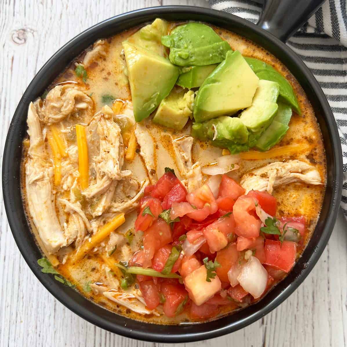 Chicken chili with avocado, pico de gallo, and shredded cheddar.
