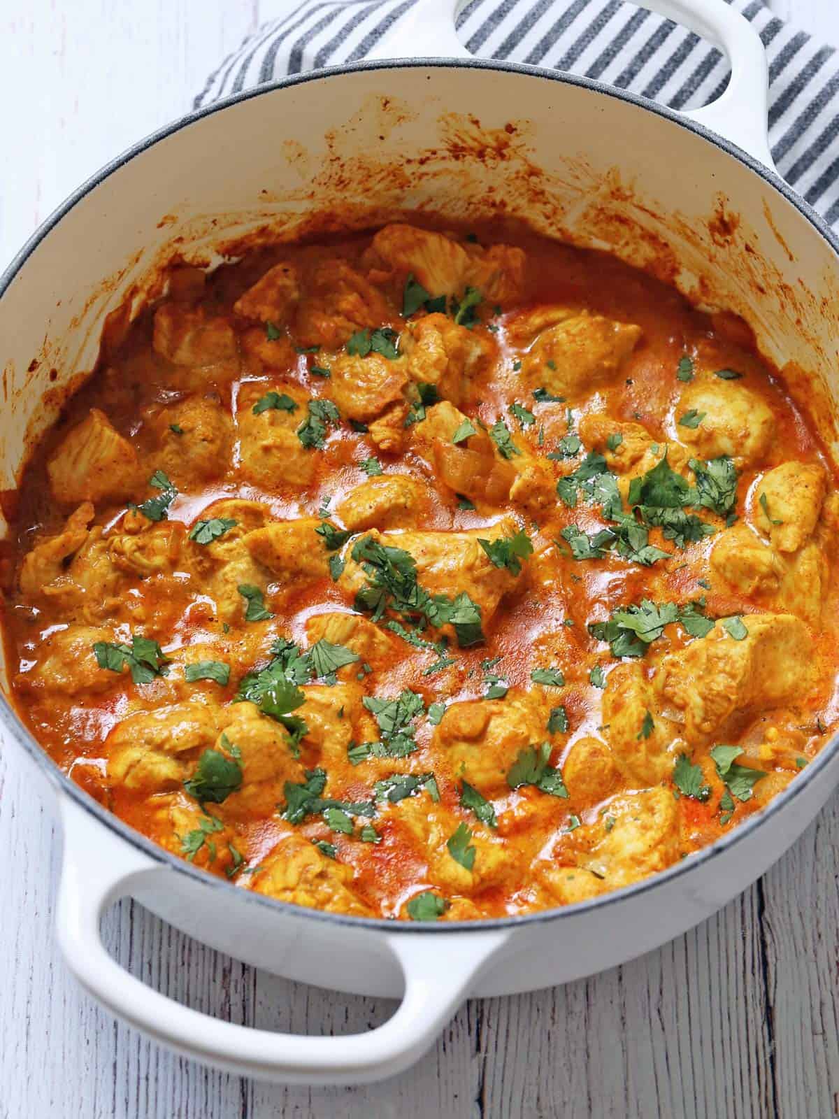 Thai chicken curry is served in a white stockpot.