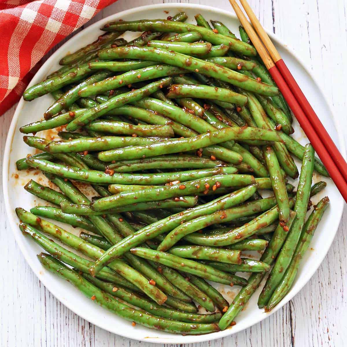 Chinese green beans are serve with chopsticks.