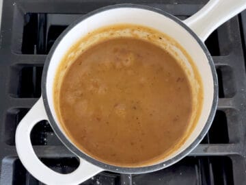 Thickened gravy in a saucepan.