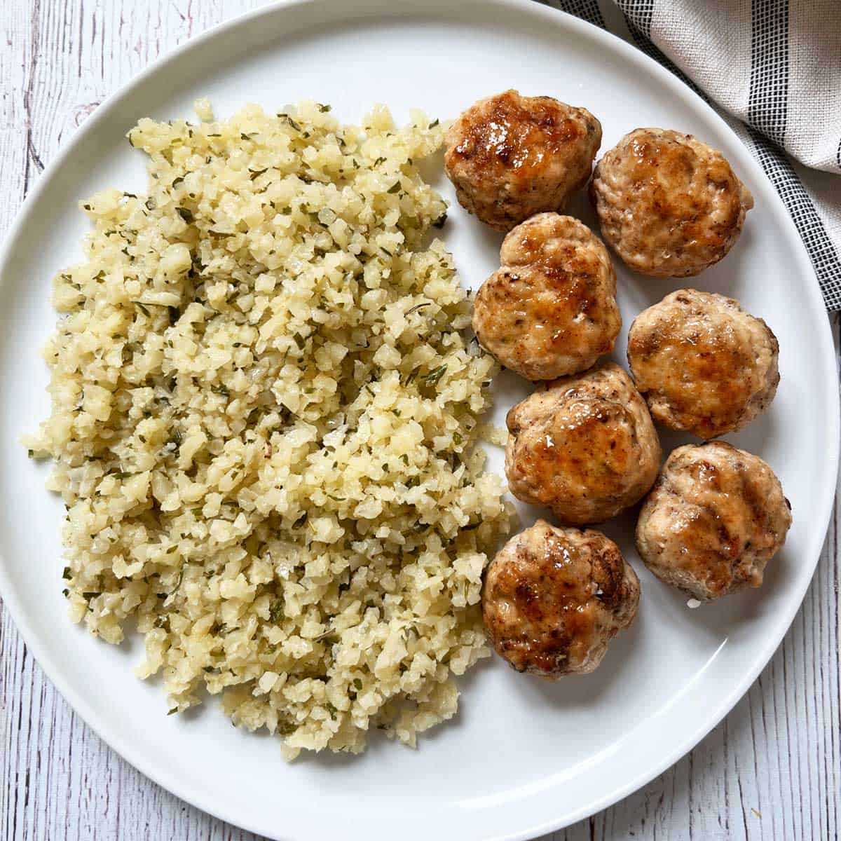 Herbed cauliflower rice is served with chicken meatballs.