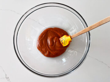 Mixing buffalo sauce in a bowl.