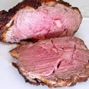 A sliced ribeye roast on a cutting board.