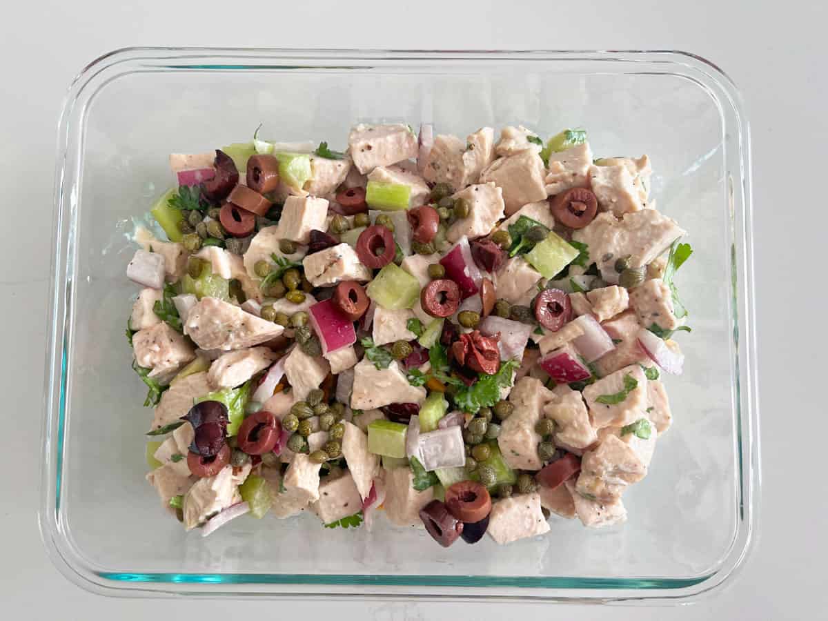 Turkey salad leftovers are kept in a glass food storage container.