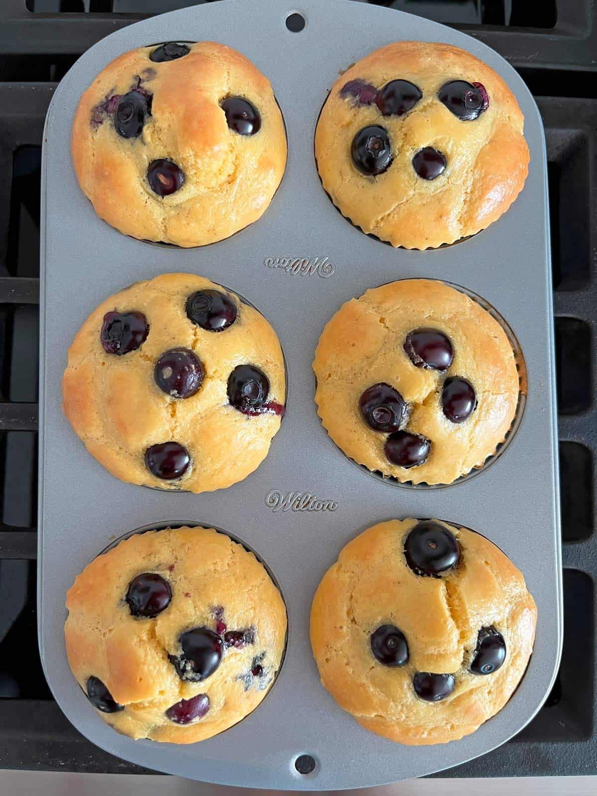 Six almond flour muffins in a muffin pan.
