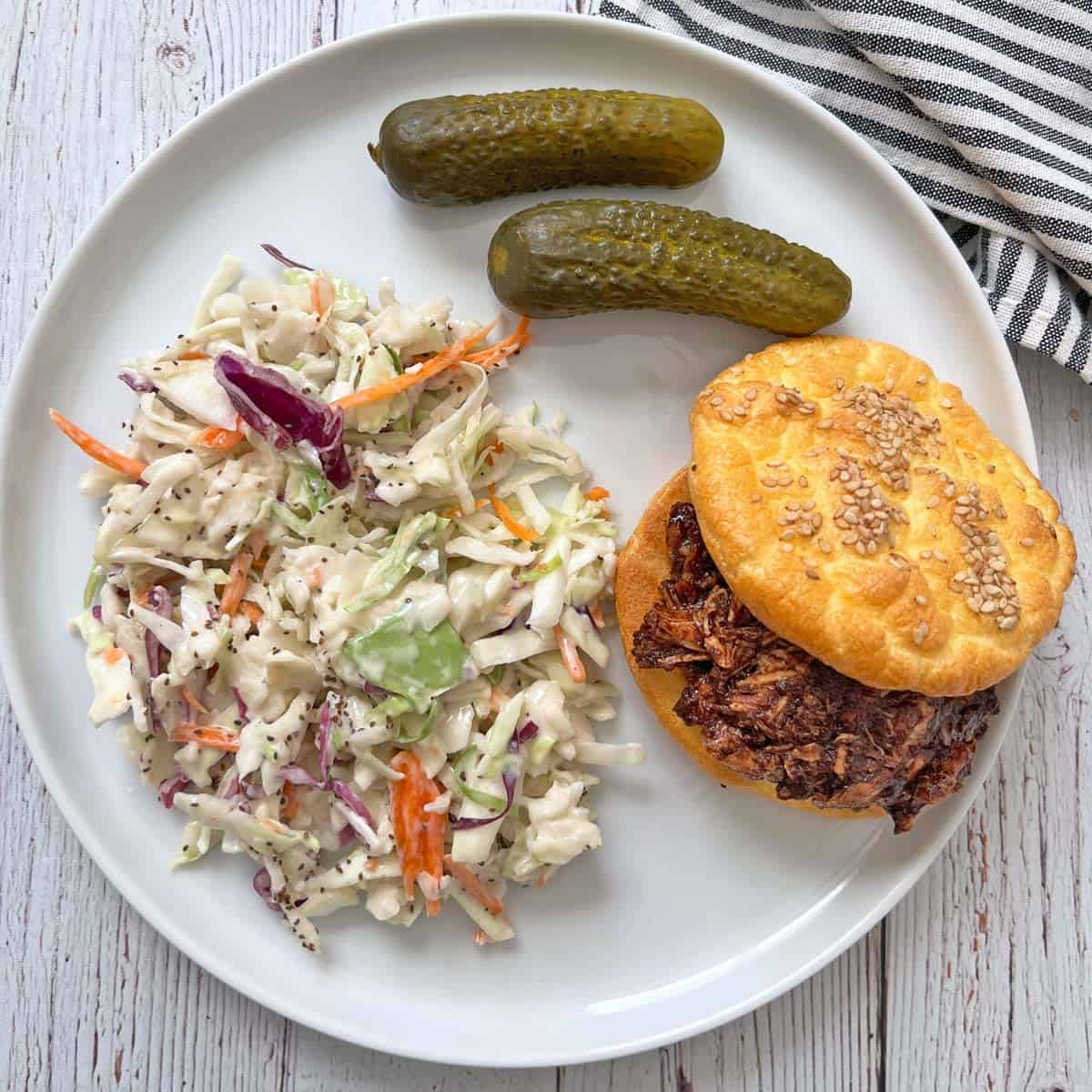 Pulled chicken is served with coleslaw.