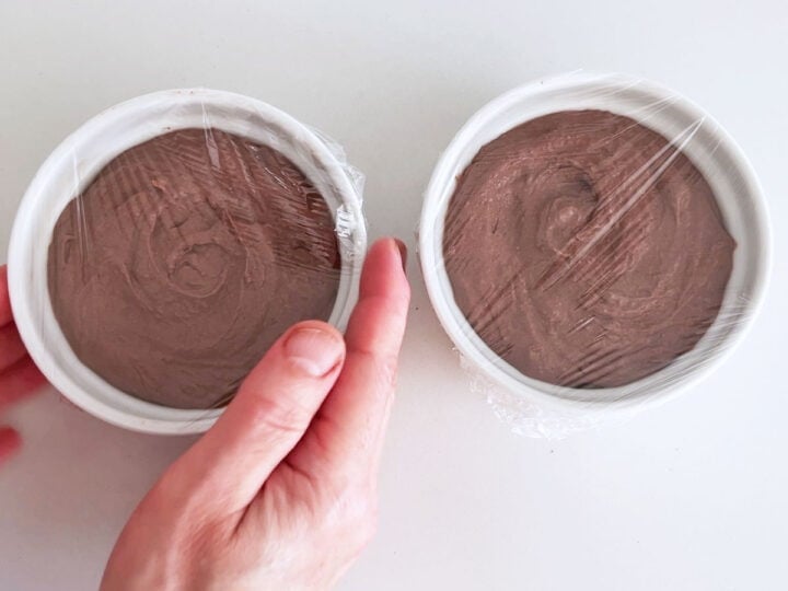 Covering the pâté with cling wrap.