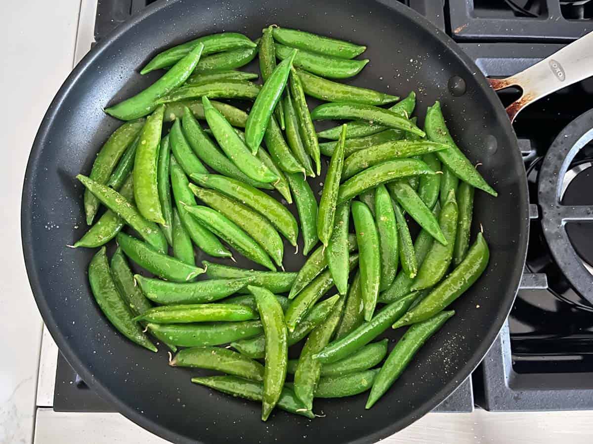 Sugar snap peas in a skillet.