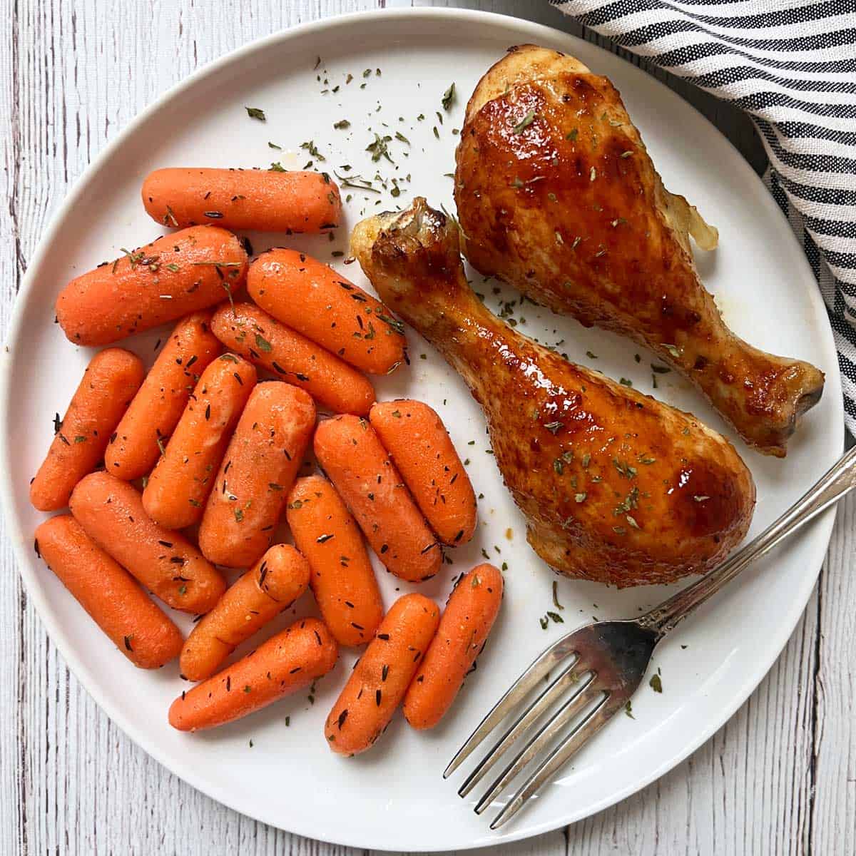 Glazed carrots are served with honey garlic chicken.
