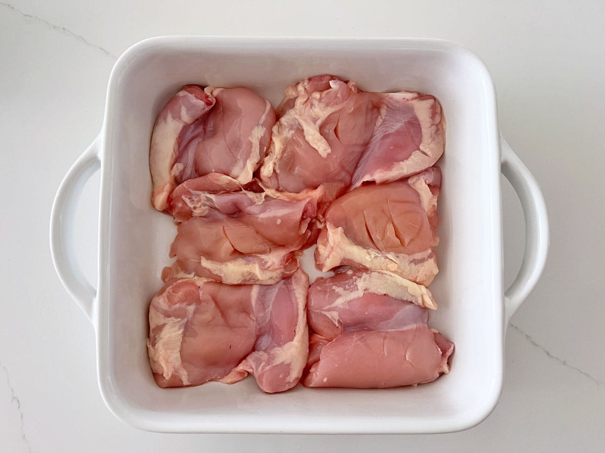 Boneless chicken thighs in a baking dish; the fat wasn't trimmed.