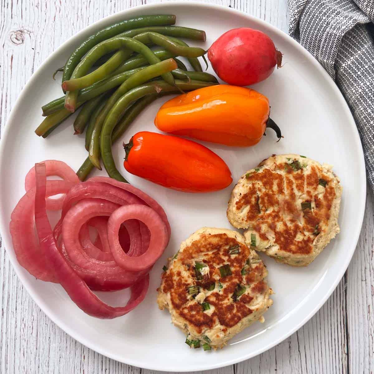 Leftover turkey patties are served with pickles.