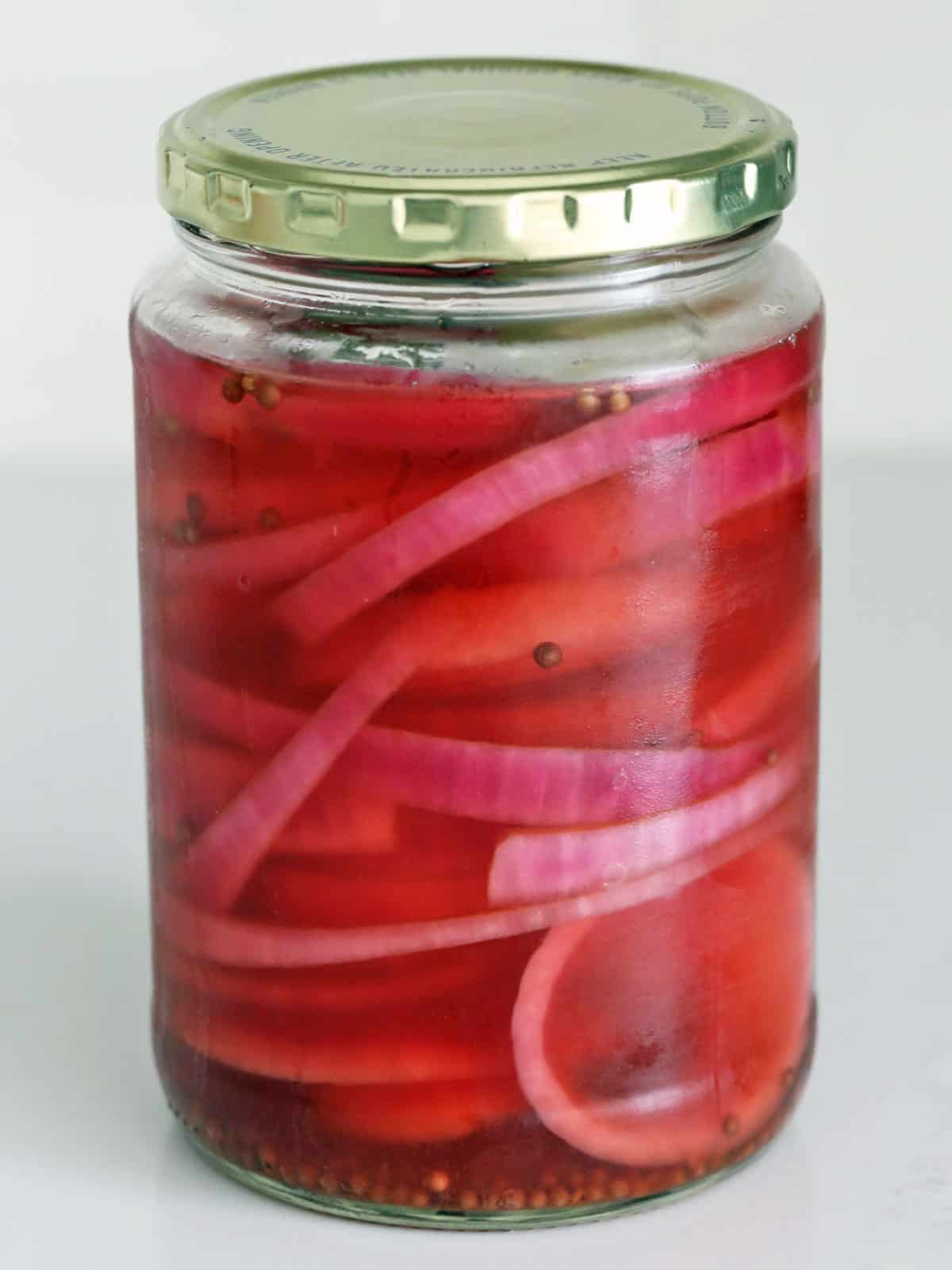 Pickling red onions in an apple cider vinegar solution.