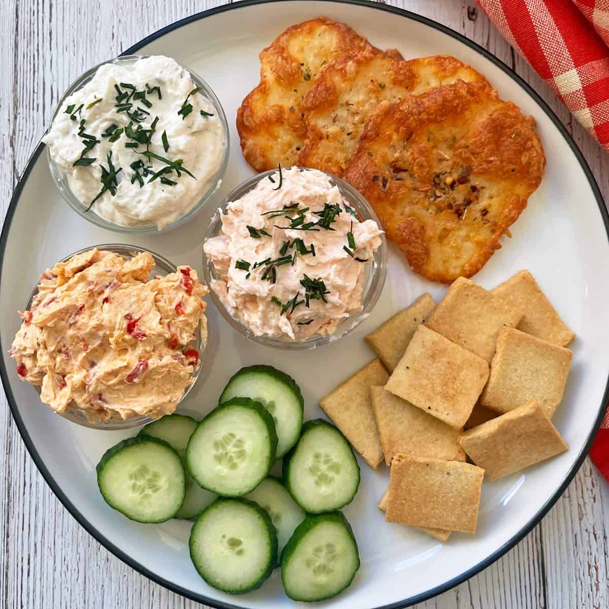 A platter with dips and crackers.