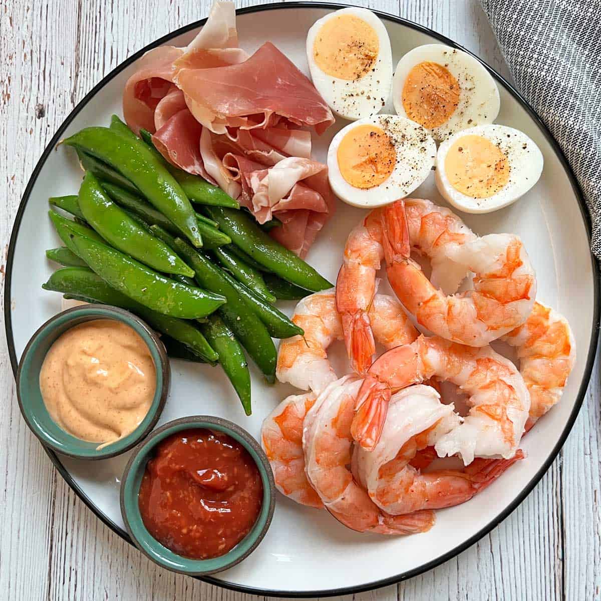 Sugar snap peas are served as part of an appetizer platter.