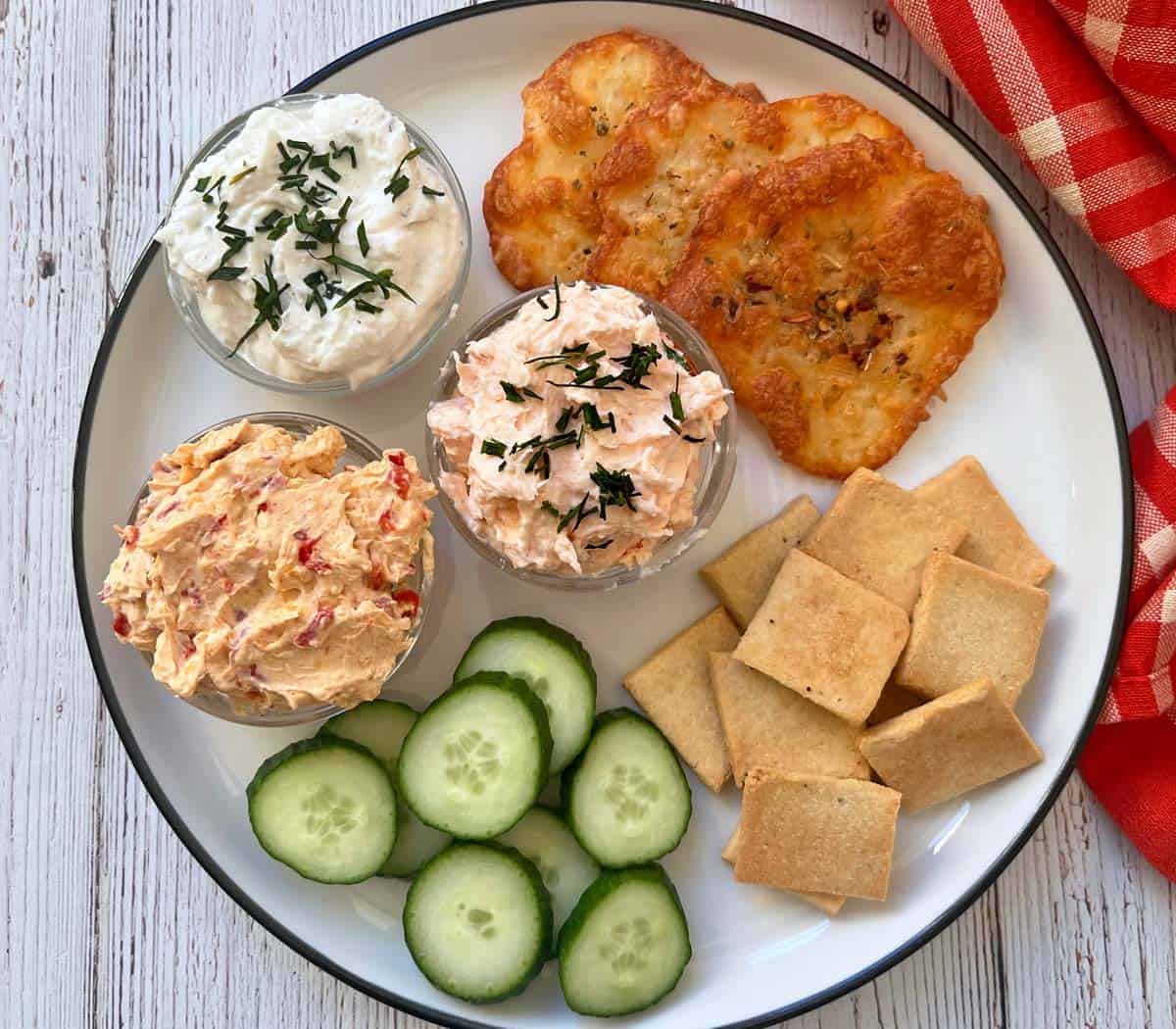 Cheese chips and crackers are served with dips.