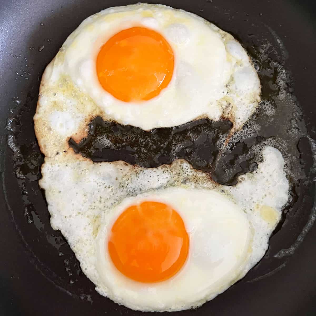 Two fried eggs in a skillet.