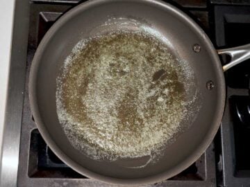 Heating the butter in the skillet.