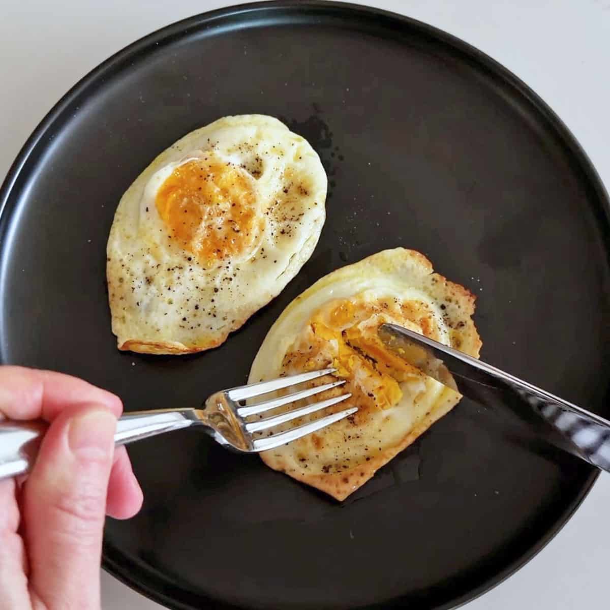 Over hard eggs on a plate.