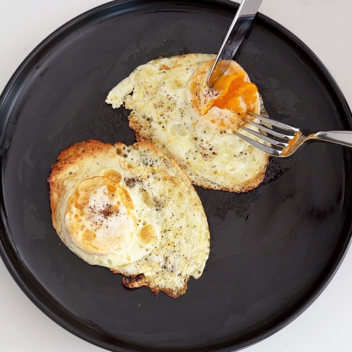 Over medium eggs on a plate.