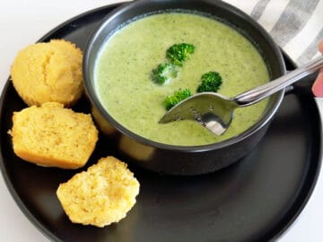 Placing a spoon into the soup.