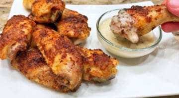 The wings are dipped in sauce.