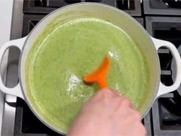 Stirring the Parmesan into the soup.