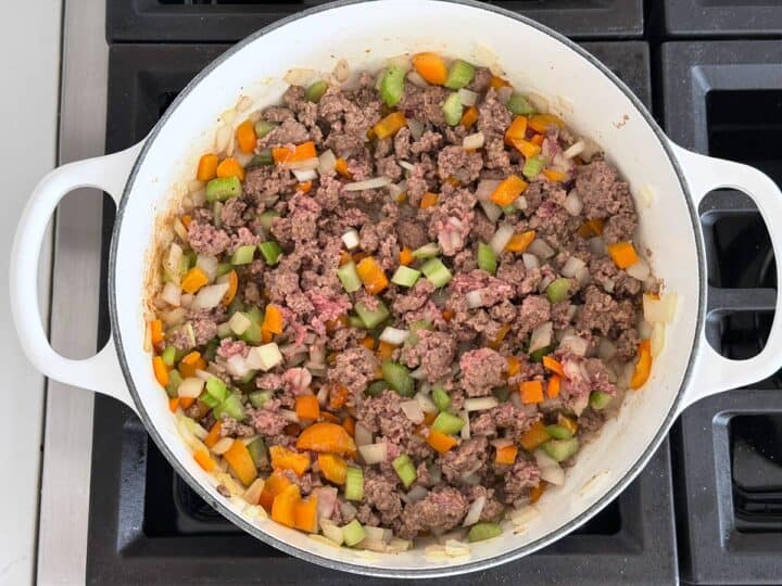 Cooking the ground beef and vegetables.