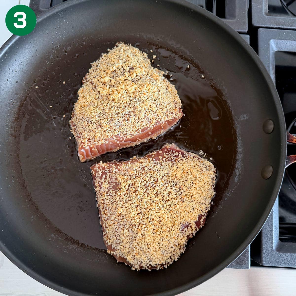 Searing sesame-crusted tuna steaks.
