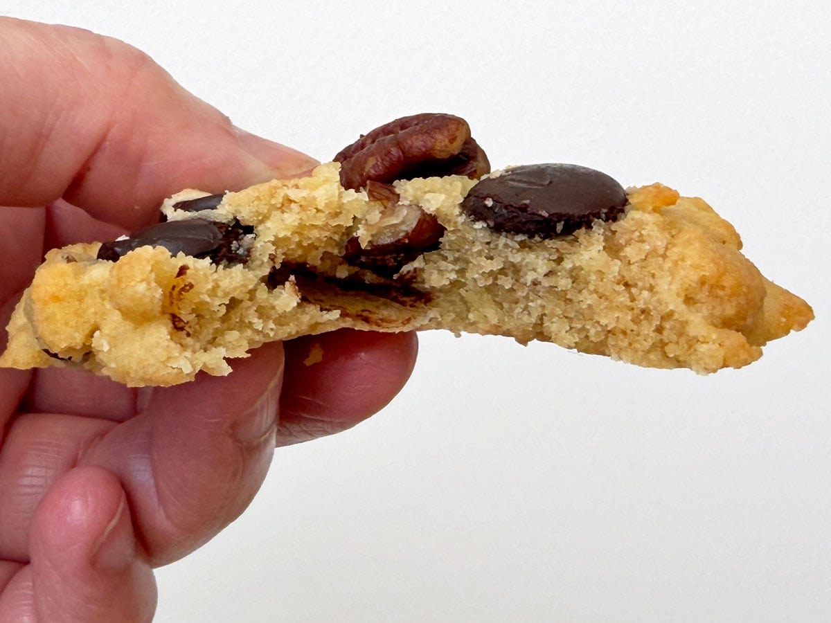 A closeup of an almond flour chocolate chip cookie to show its texture.