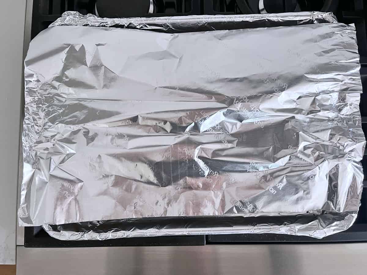 Protecting the chicken with foil.